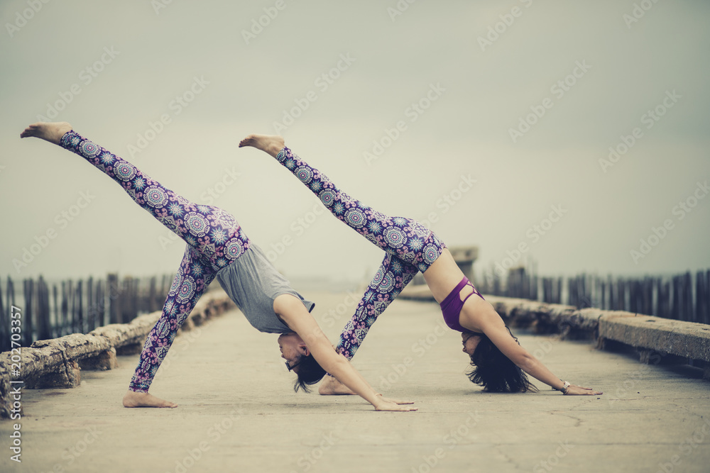 Couple in park practising pair yoga poses – Jacob Lund Photography Store-  premium stock photo