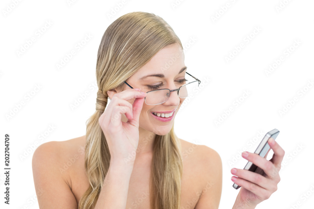 Calm young blonde woman looking at her mobile phone Calm young blonde woman looking at her mobile phone