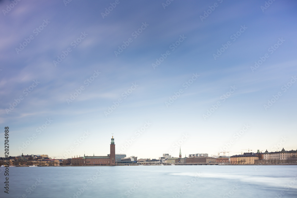 Beautiful scenic panorama of the Old City (Gamla Stan) cityscape pier architecture with historic town houses with colored facade in Stockholm, Sweden. Creative long time exposure landscape photography