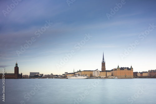 Beautiful scenic panorama of the Old City (Gamla Stan) cityscape pier architecture with historic town houses with colored facade in Stockholm, Sweden. Creative long time exposure landscape photography