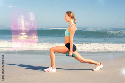 Fit woman doing weighted lunges on the beach against fitness interface