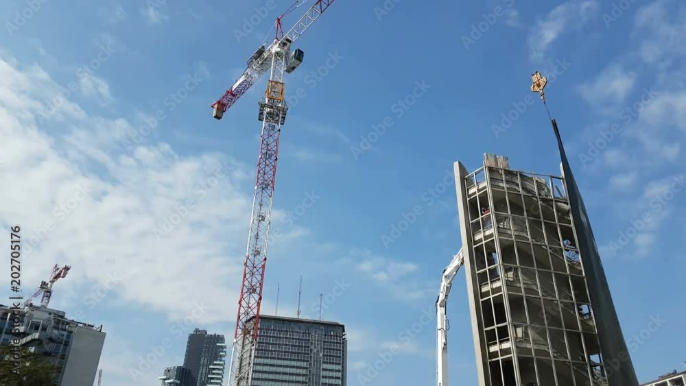 building demolition with blue sky in the background - 4k footage

 