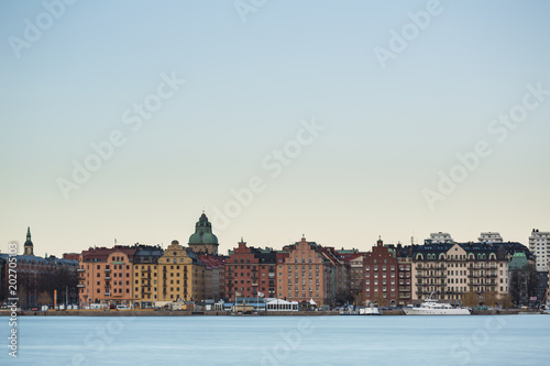 Beautiful scenic panorama of the Old City (Gamla Stan) cityscape pier architecture with historic town houses with colored facade in Stockholm, Sweden. Creative long time exposure landscape photography