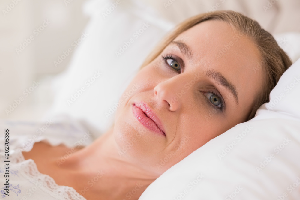 Natural content woman resting in bed