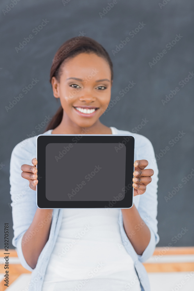 Smiling black woman holding a tablet computer Smiling black woman holding a tablet computer