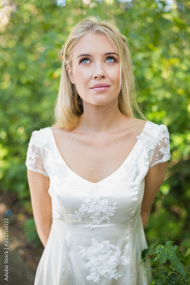 Smiling beautiful bride looking up Smiling beautiful bride looking up