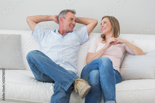Happy relaxed couple sitting on sofa © WavebreakmediaMicro