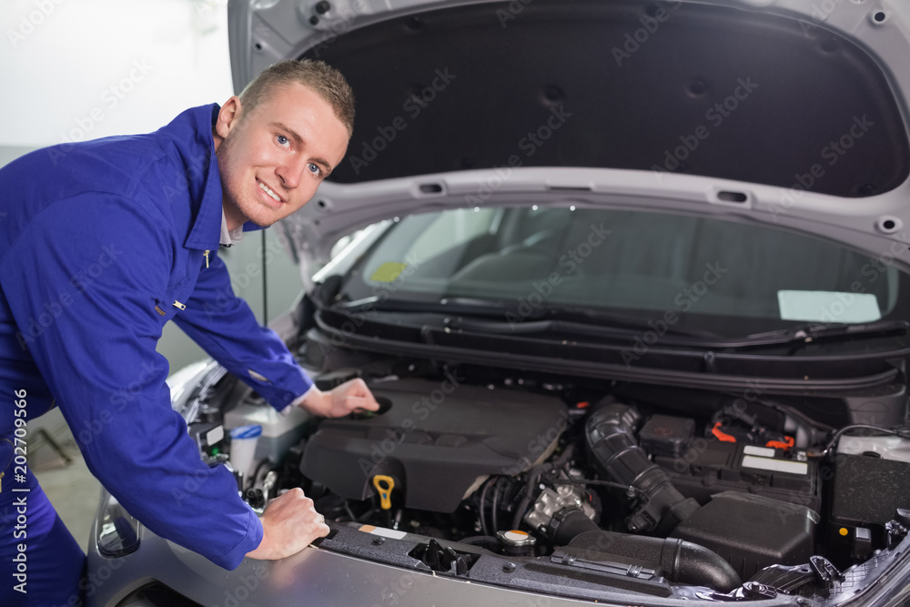 Smiling mechanic looking at camera Smiling mechanic looking at camera