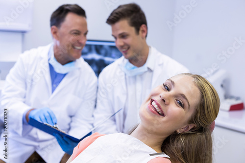 Portrait of smiling female patient sitting on dental chair