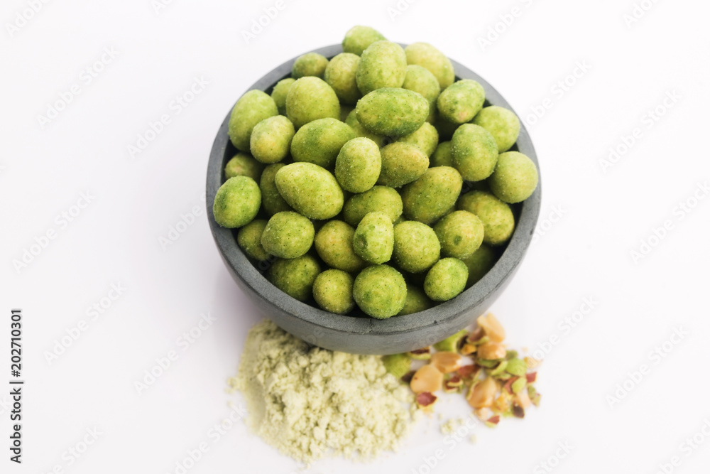 Pile of wasabi coated peanuts in bowl Pile of wasabi coated peanuts in bowl