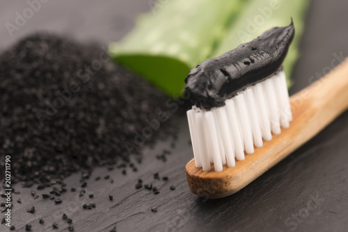 Toothbrush with black charcoal toothpaste with aloe vera