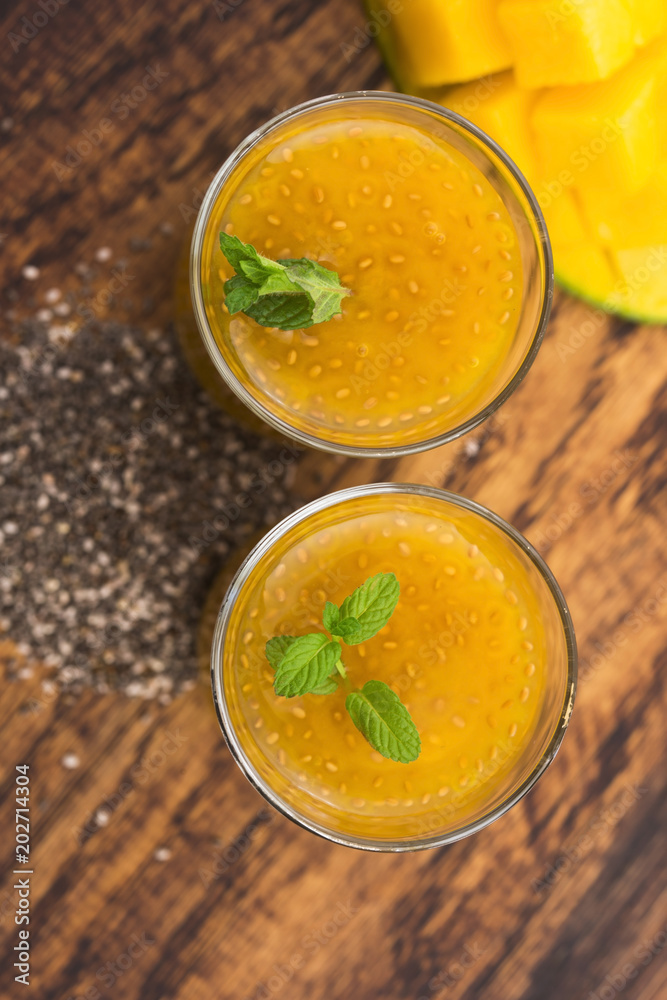 Fresh mango smoothie in glass with chia seeds Fresh mango smoothie in glass with chia seeds