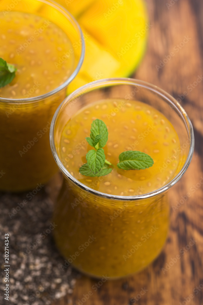Fresh mango smoothie in glass with chia seeds Fresh mango smoothie in glass with chia seeds