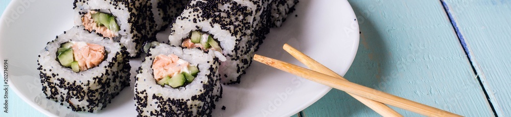 Banner of Maki Sushi - Roll made of Cream Cheese, Tamago, Cucumber and Smoked Eel inside. Black Tobiko outside Banner of Maki Sushi - Roll made of Cream Cheese, Tamago, Cucumber and Smoked Eel inside. Black Tobiko outside