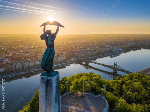 Budapest, Hungary - Aerial view of the beautiful Hungarian Statue of Liberty with Liberty Bridge and skyline of Budapest at sunrise with clear blue sky photo