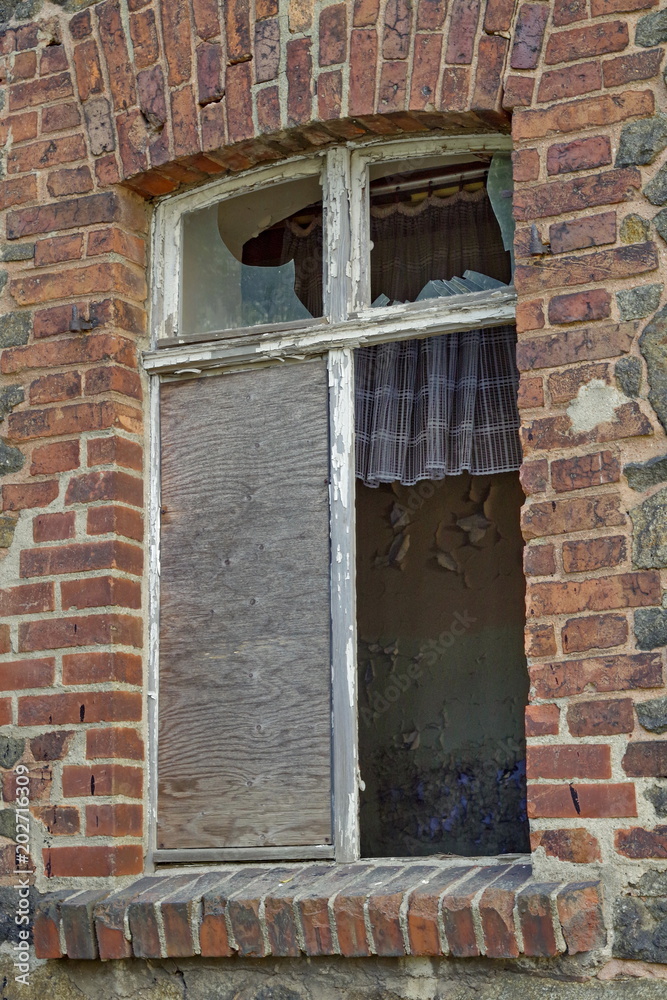 Broken window of a brickhouse
