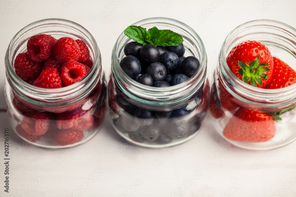 Glass jars of fresh berries Glass jars of fresh berries