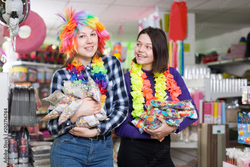 women with bagfuls of multicolored confetti