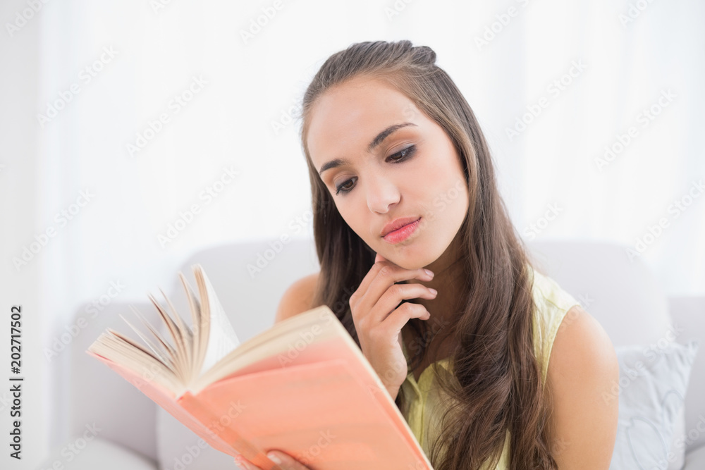 Thoughtful young brunette reading a book Thoughtful young brunette reading a book