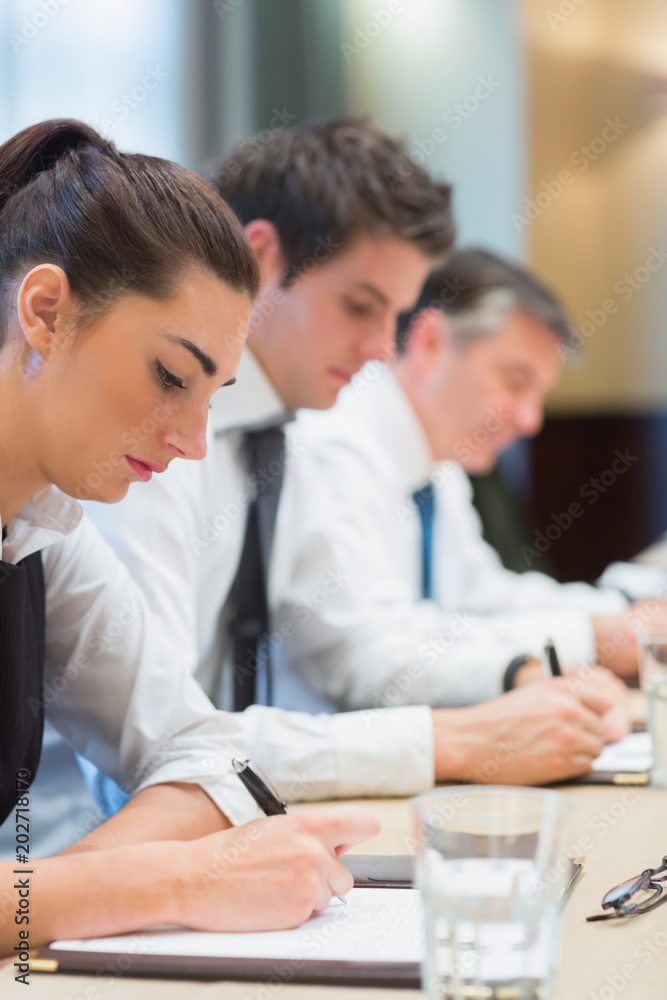 Concentrated business people taking notes Concentrated business people taking notes