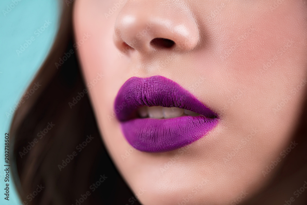 Close up of the woman's open lips. Purple lipstick, lip gloss, cosmetics. Close up of the woman's open lips. Purple lipstick, lip gloss, cosmetics.