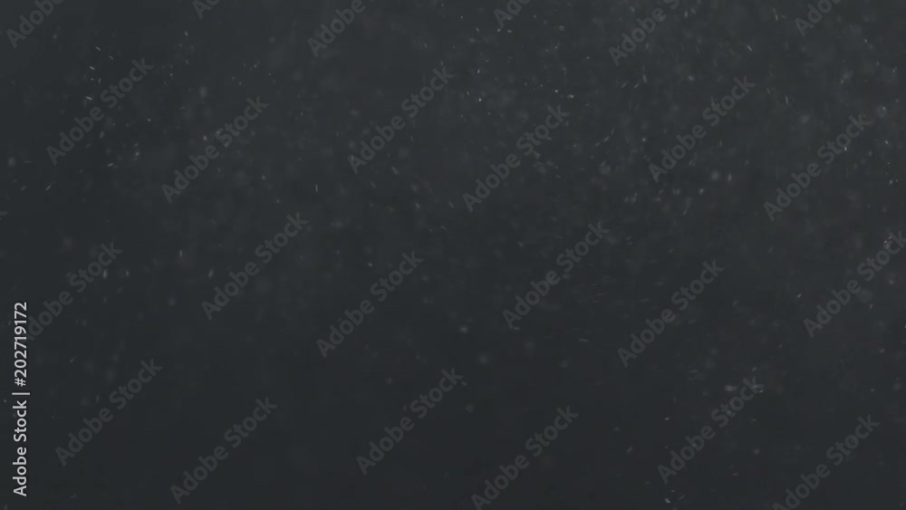 Slow motion real dust explosive wave in air over dark background Slow motion real dust explosive wave in air over dark background