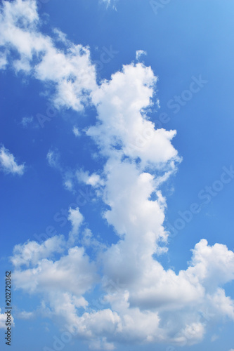 Bright cloud shape like The women standing and  cross one s arm on beautiful blue sky   Fluffy clouds formations at tropical zone   