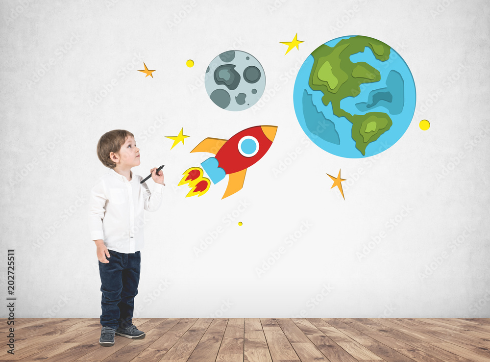 Adorable little boy drawing space travel Adorable little boy drawing space travel