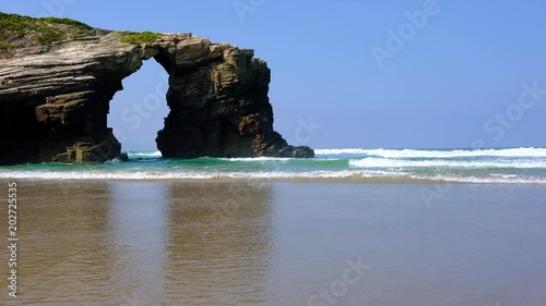Beach of the Cathedrals. Natural arch at Las Catedrales beach known as Praia de Augas Santas (Beach of the Holy Waters) in Galicia, Spain photo
