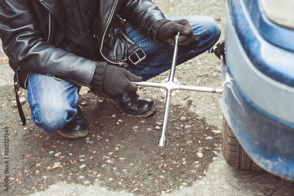 man changing wheel on a car man changing wheel on a car
