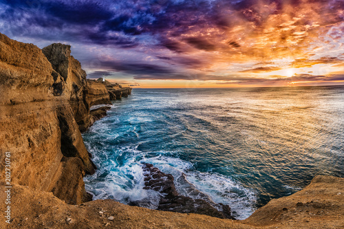 New Zealand is the ultimate destination for adventure, holiday and exploration. Beautiful places everywhere. This is amazing colorful sunrise on the Northern Island. Cliffs, ocean, wind.