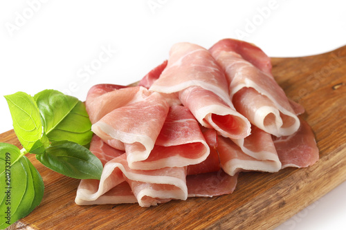 prosciutto on wooden cutting board