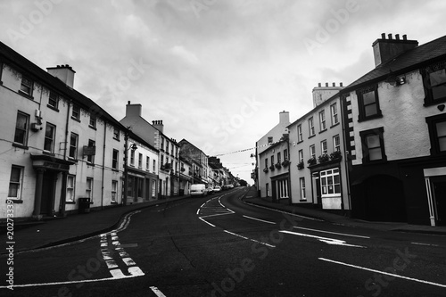 Row of pubs and bars in the city of Ballycastle, Causeway coast in Northern Ireland, UK. Black and white