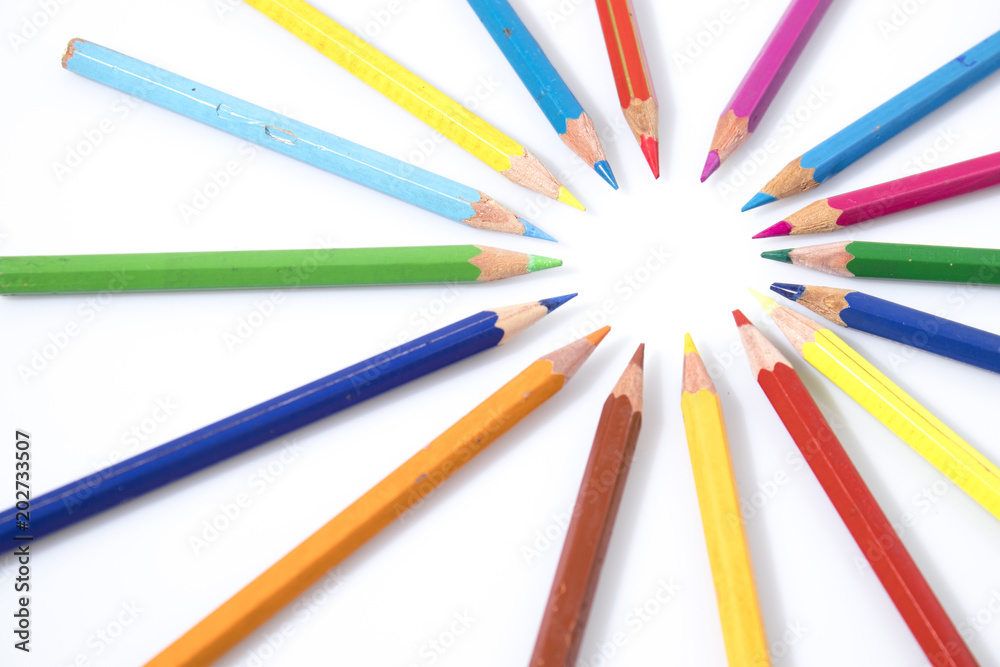 Many colored pencils in circle in a white background
