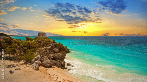 Caribbean beach at the cliff in Tulum at sunset, Mexico photo