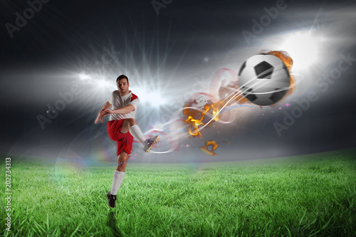 Football player in white kicking against football pitch under bright lights © vectorfusionart