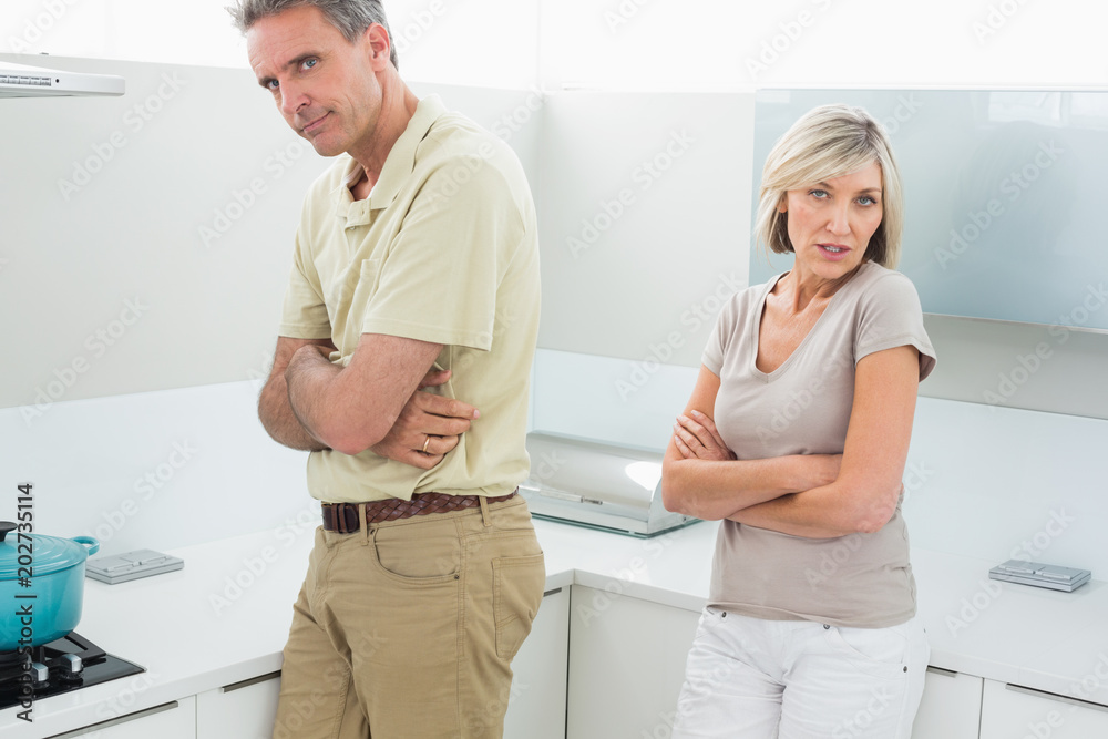 Angry couple after a fight in kitchen Angry couple after a fight in kitchen