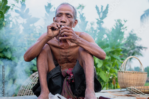 Elderly man was sitting smoke