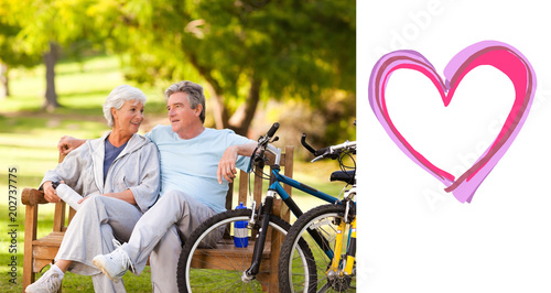 Elderly couple with their bikes against heart