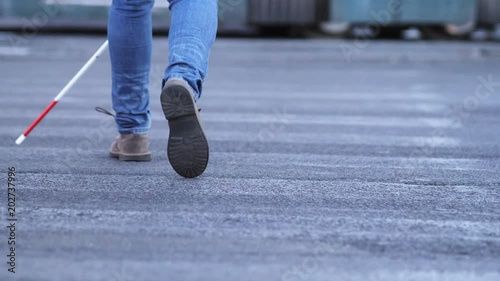 close up on Blind man's leg crossing in the street with his cane- slw motion