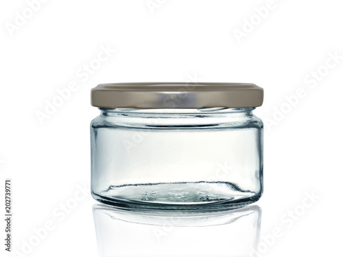 glass jar for canning with iron lid isolated on white background with reflection