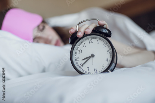 Sleeping girl with an alarm clock