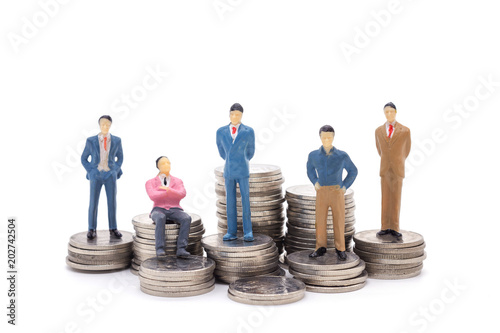 Toy businessman and coins on white background