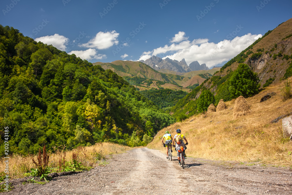 Mountain bikers are travelling in the highlands of Tusheti region, Georgia