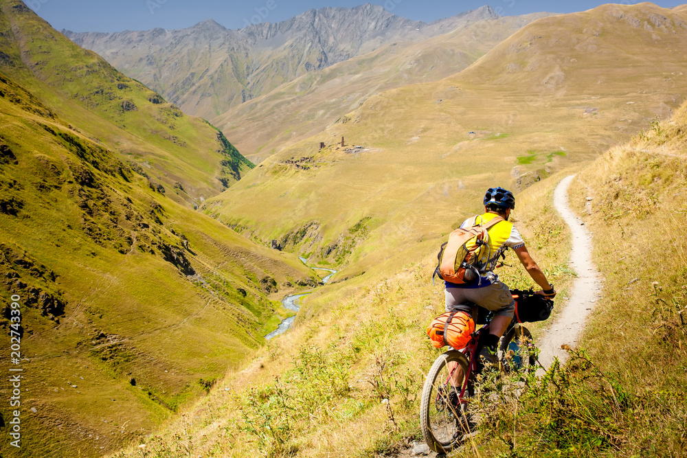 Mountain biker is travelling in the highlands of Tusheti region, Georgia