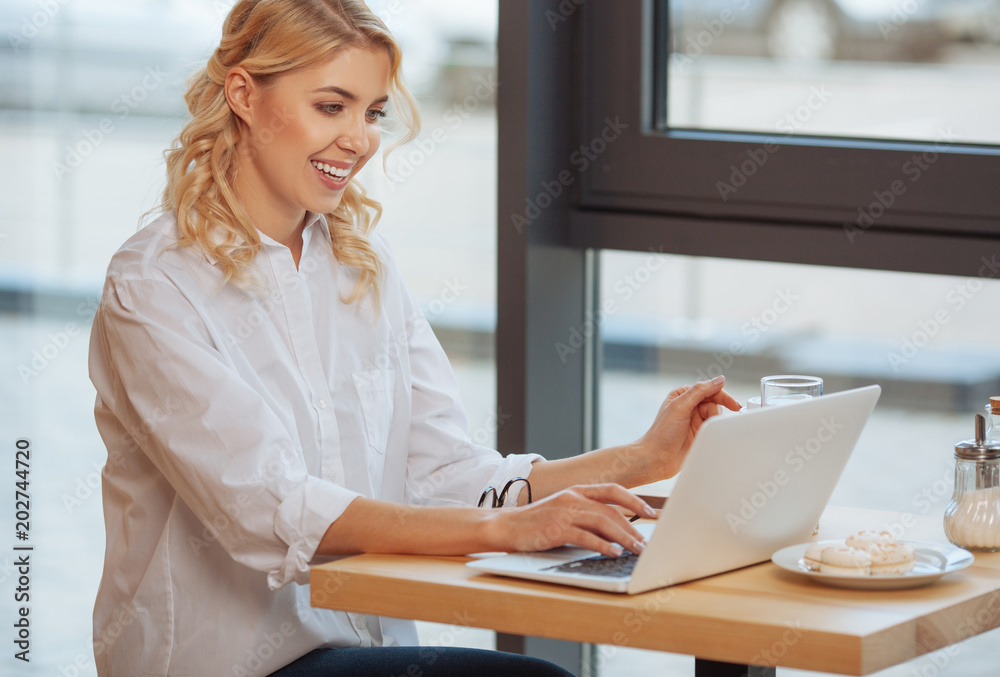 Happy delighted businesswoman enjoying her work Happy delighted businesswoman enjoying her work