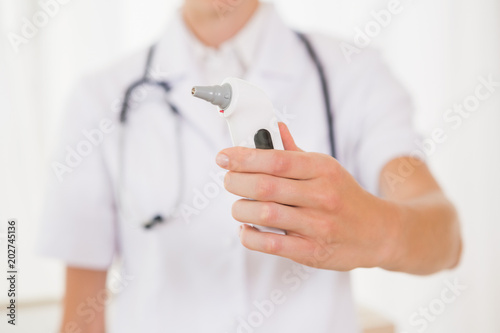 Doctor with stethoscope and thermometer  photo