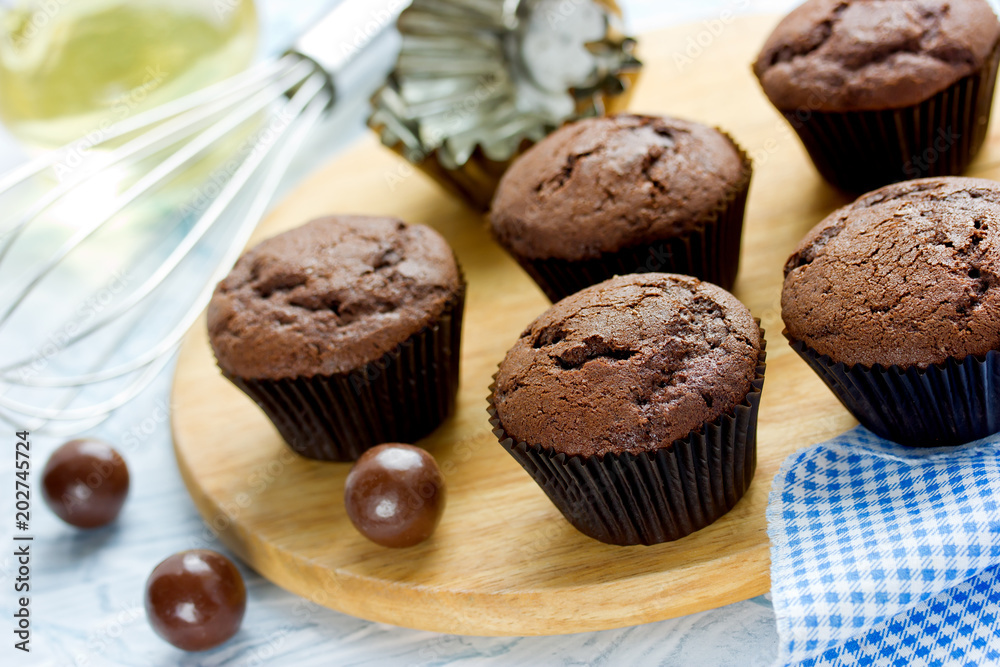 Chocolate cupcakes, delicious homemade chocolate cakes with cracks in brown paper cases Chocolate cupcakes, delicious homemade chocolate cakes with cracks in brown paper cases