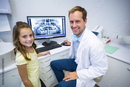 Smiling young patient and dentist in dental clinic
