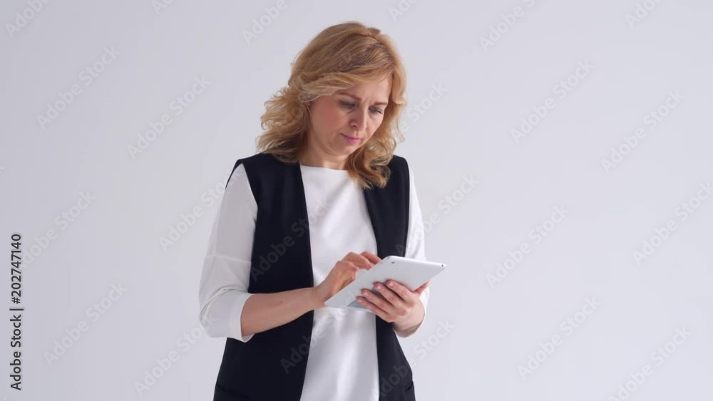 Concentrated mature woman using tablet Concentrated mature woman using tablet